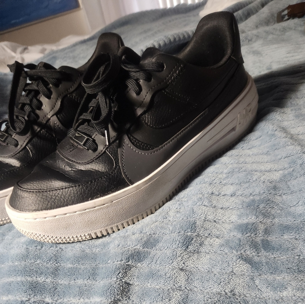 Nike Air Force 1, Black with gray swoosh, worn but still has a lot of life.
